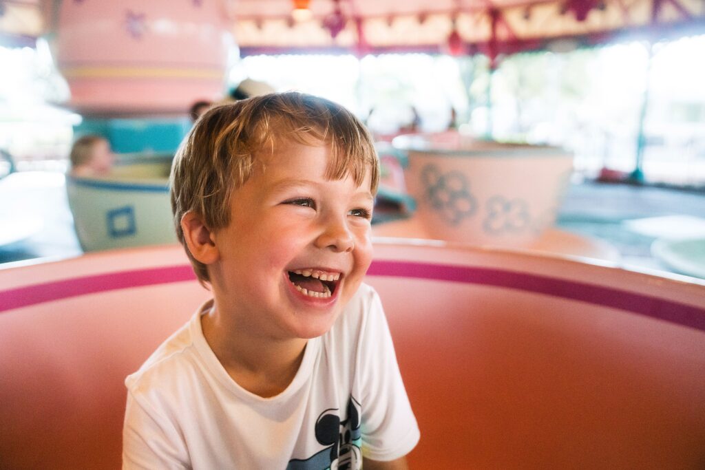 Orlando photographer's photo of boy on mad tea party ride in Disney World in Summer