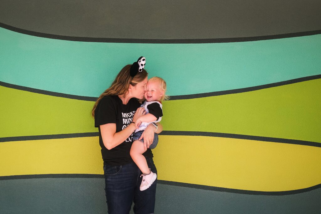 Mother and baby girl at colored wall in EPCOT at Walt Disney World