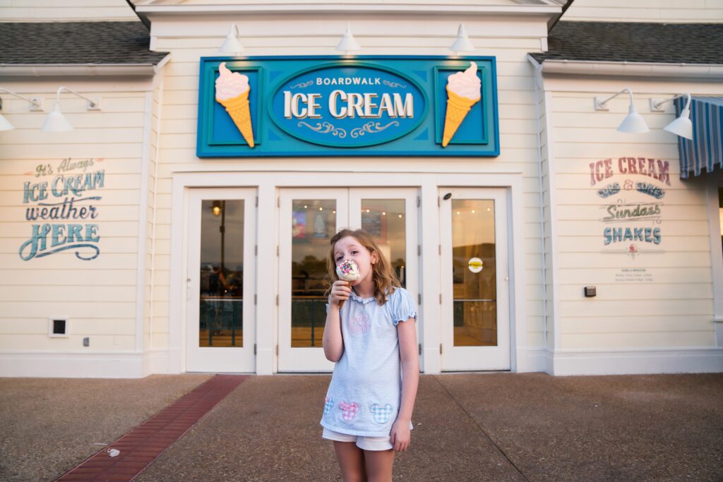 Girl eating ice cream during photoshoot at Disney's Boardwalk in Walt Disney World