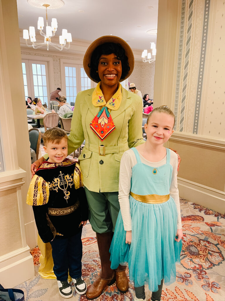 Tianan with two kids dressed as a knight and Jasmine at the Grand Floridian Resort at Walt Disney World