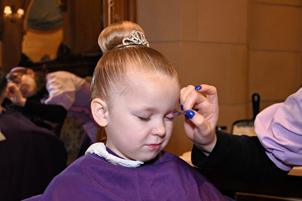 Girl getting makeup done at Bibbidi Bobbidi Boutuique Magic Kingdom