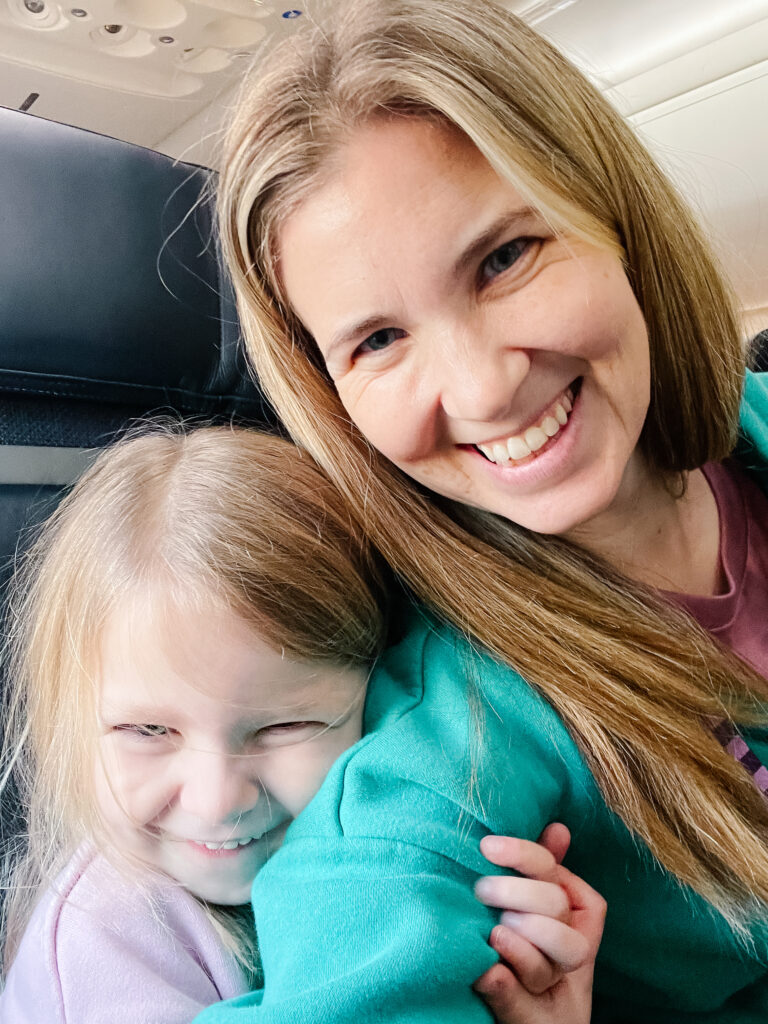 Mother and daughter on airplane after landing