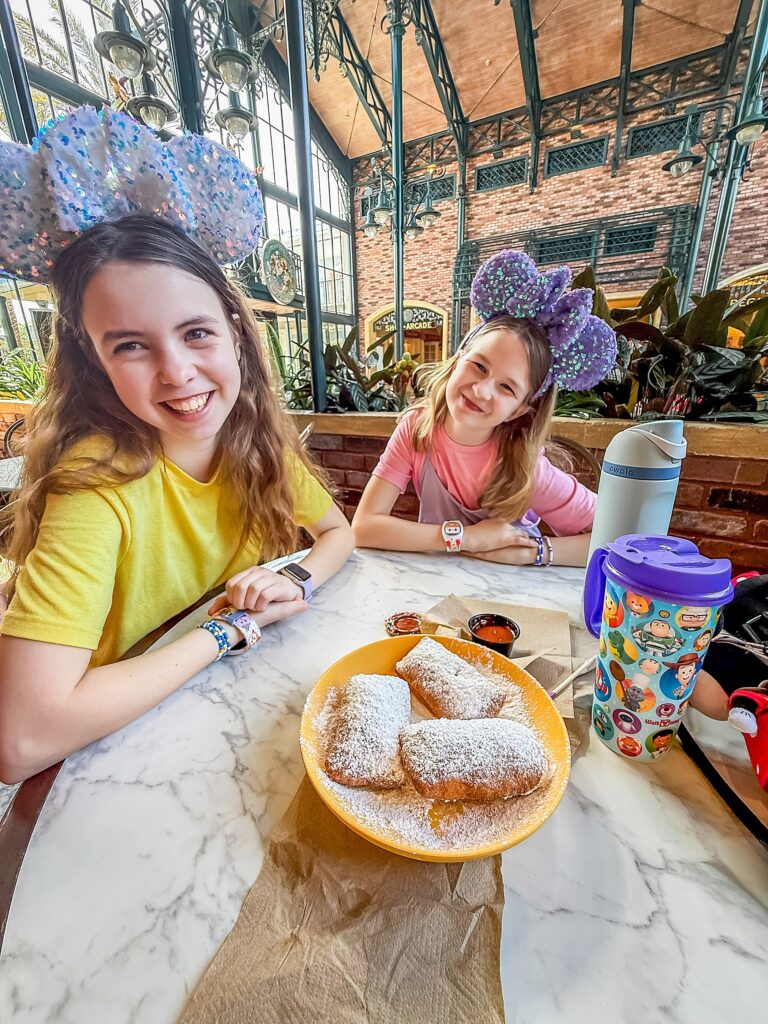 Girls smiling with beignets at Port Orleans French Quarter Resort