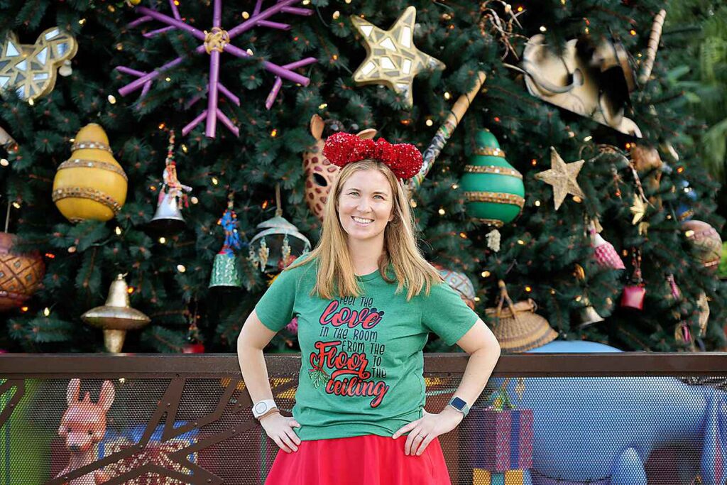 Disney World at Christmas Animal Kingdom Tree with Woman smiling